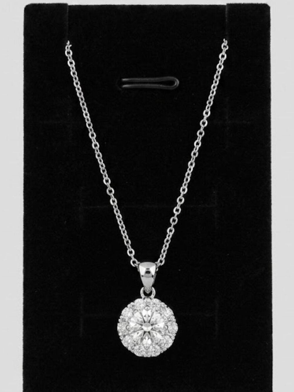 XL15 Bianca Star 1 ct  Molssanite with a pave of stone around it